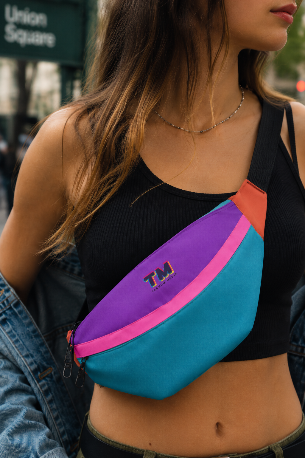 Woman wearing a colorful multicolor fanny pack as a crossbody bag in New York City.
