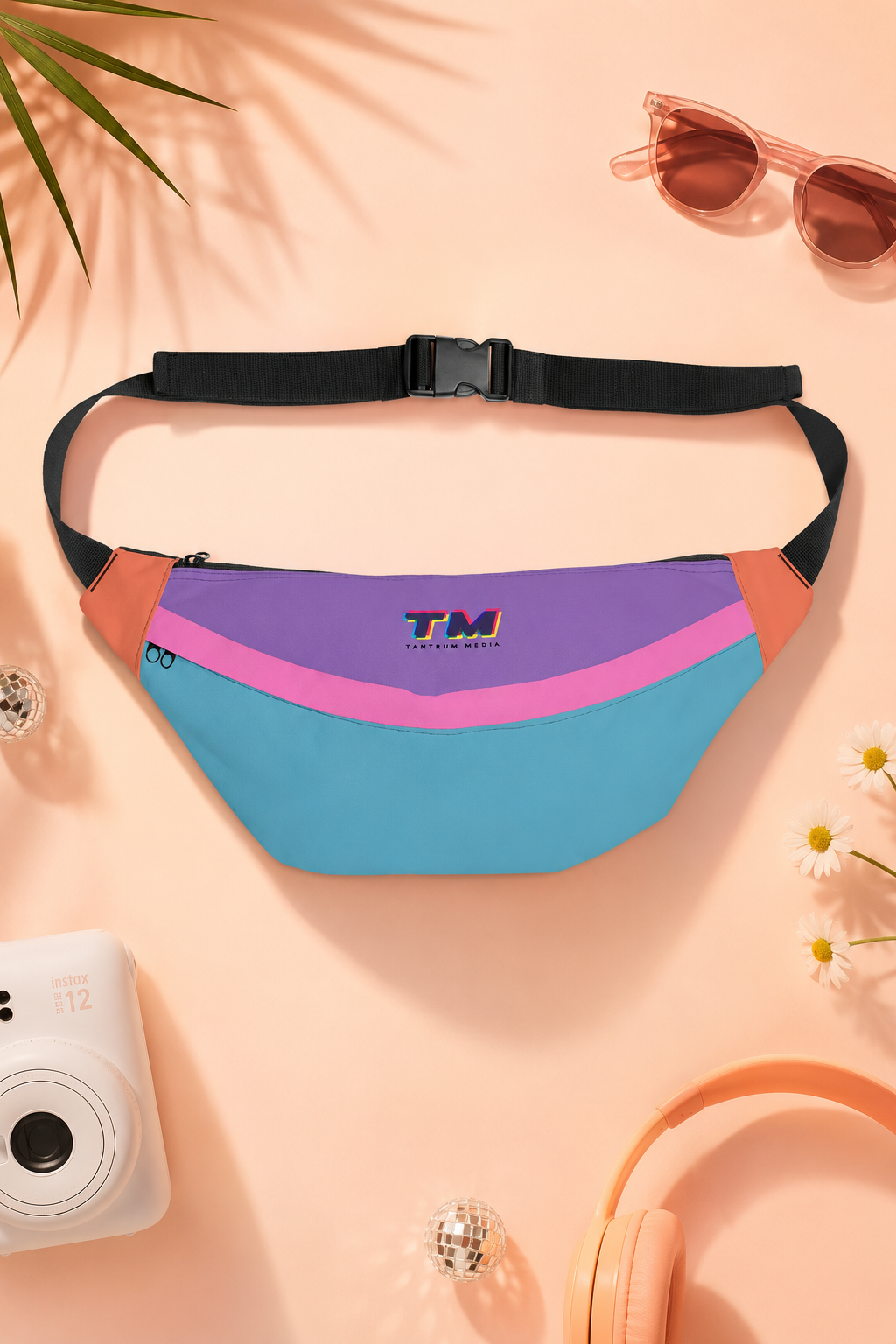 Colorful multicolor fanny pack in an editorial flat lay with pastel lifestyle accessories.