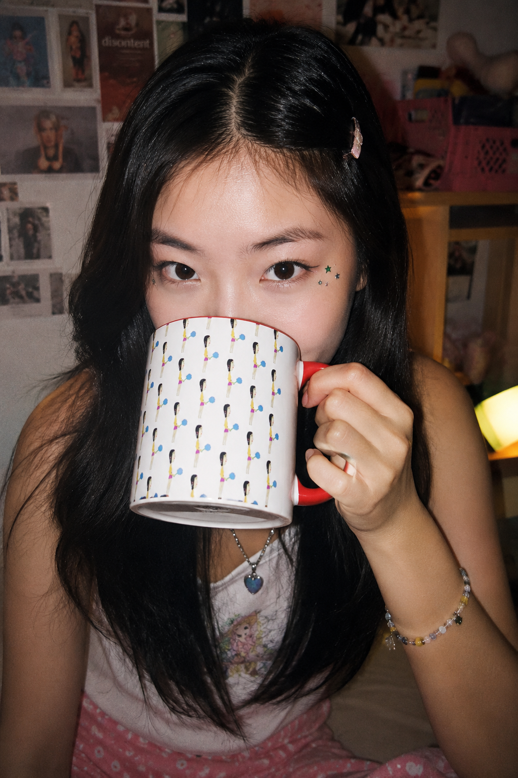 Young woman drinking from the Cotton Candy Illustrated Mug in a colorful bedroom setting.
