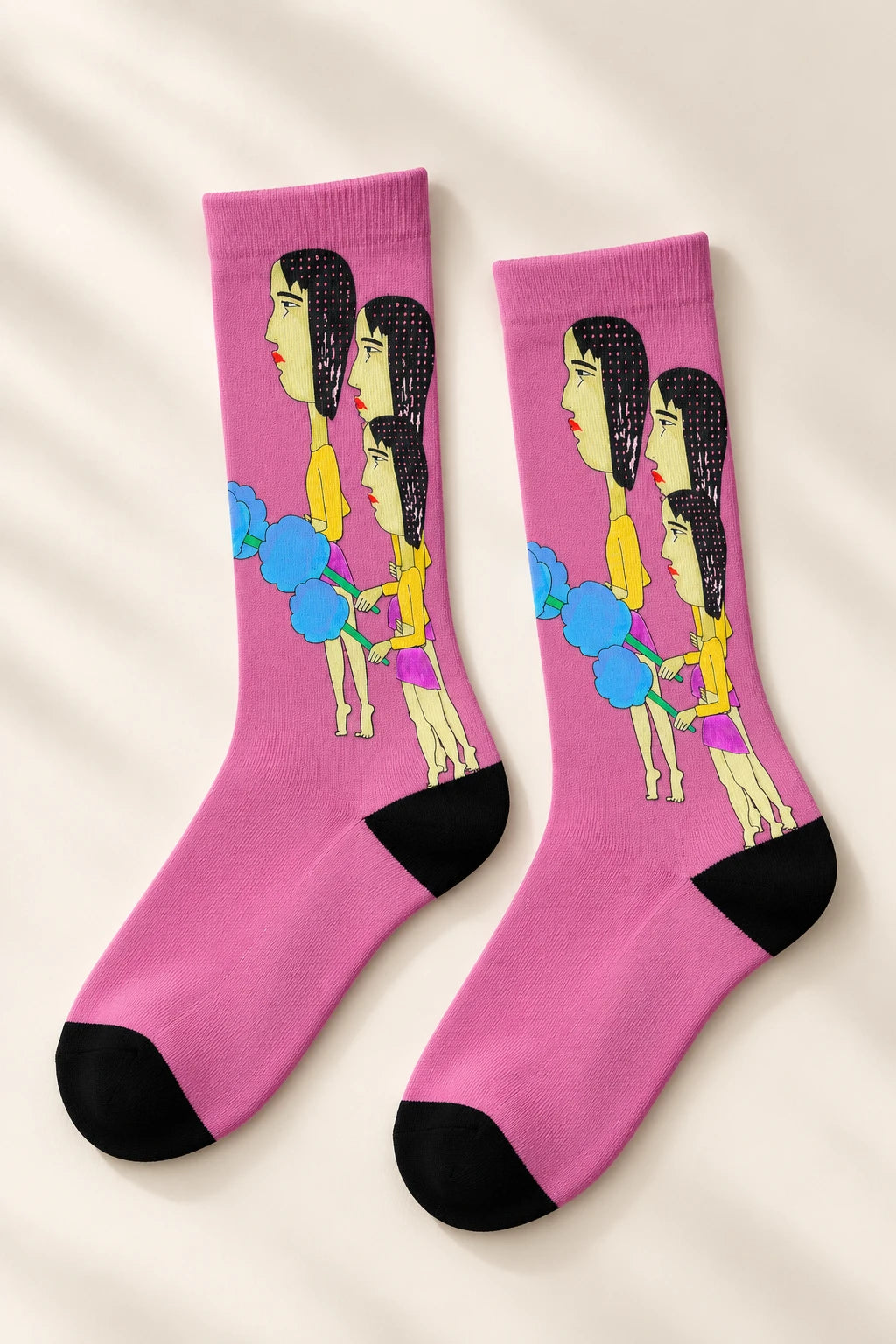 Angled view of pink Cotton Candy Pop Art Crew Socks with hand-drawn women and blue cotton candy