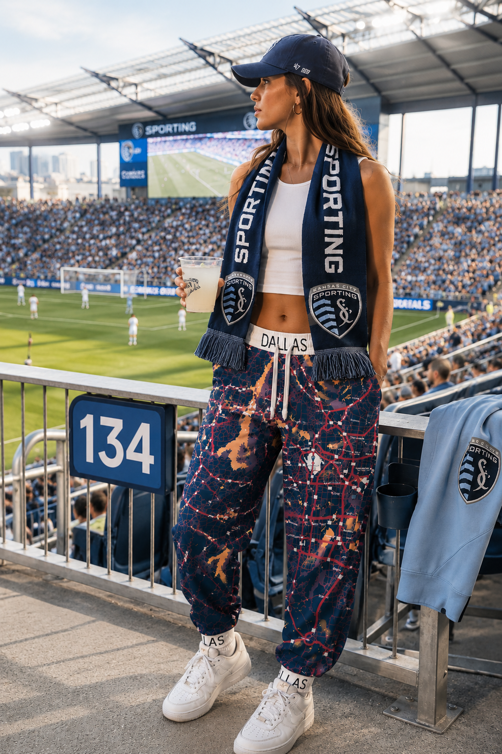 Female Gen Z wearing Dallas Map Joggers at a soccer stadium in a cinematic sports-inspired editorial photo.
