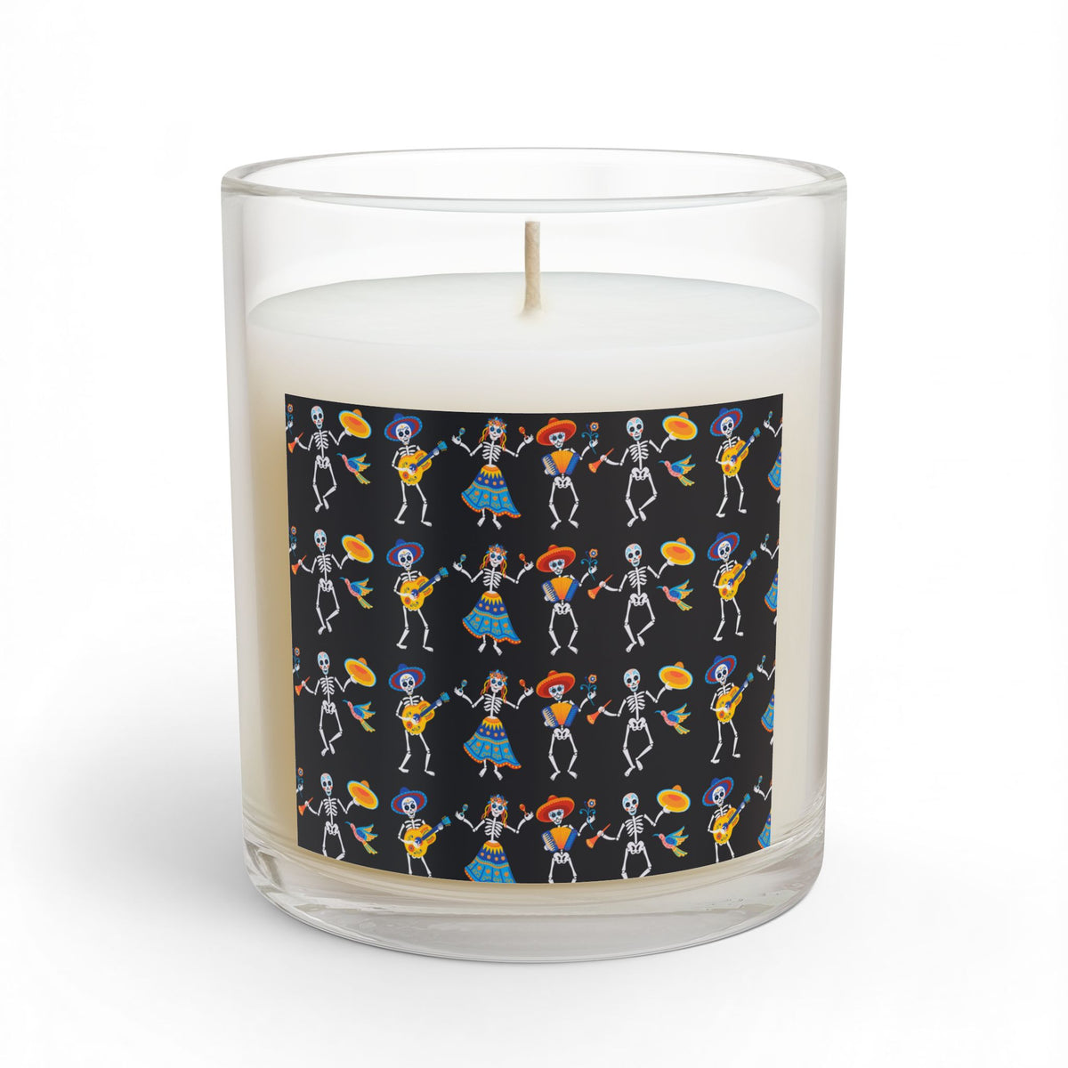 White glass candle with a black label featuring colorful dancing skeleton artwork