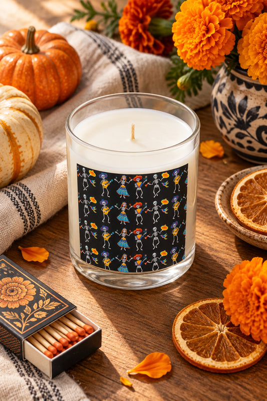 Dancing Skeletons candle styled with pumpkins, marigolds, dried orange slices and matches in a cozy fall flat lay