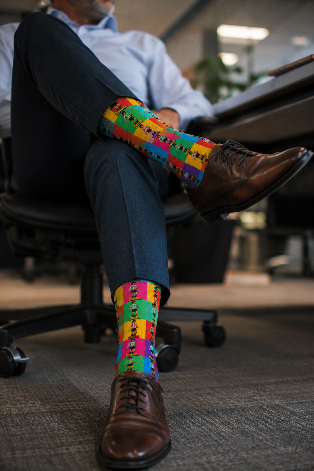 Gen X male wearing Diego Maradona pop art socks in corporate office
