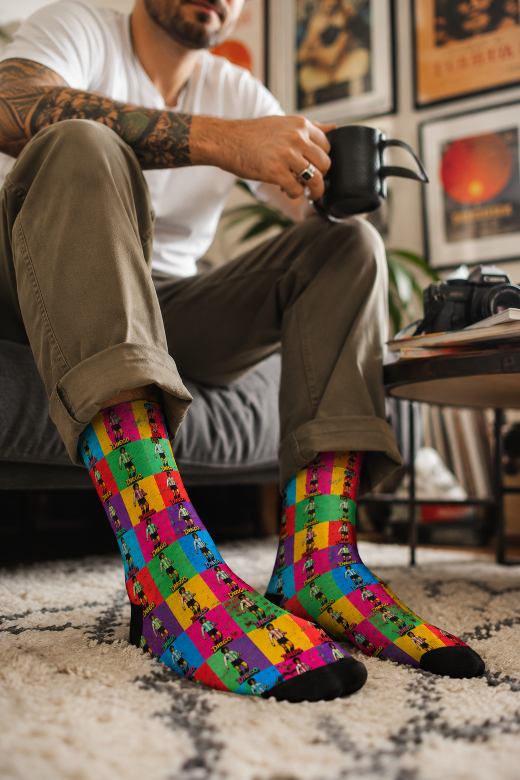 Millennial male wearing Diego Maradona crew socks in living room