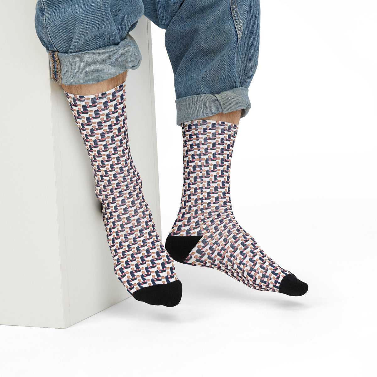 Person wearing Donald Trump Crew Socks with cuffed jeans in a casual seated look