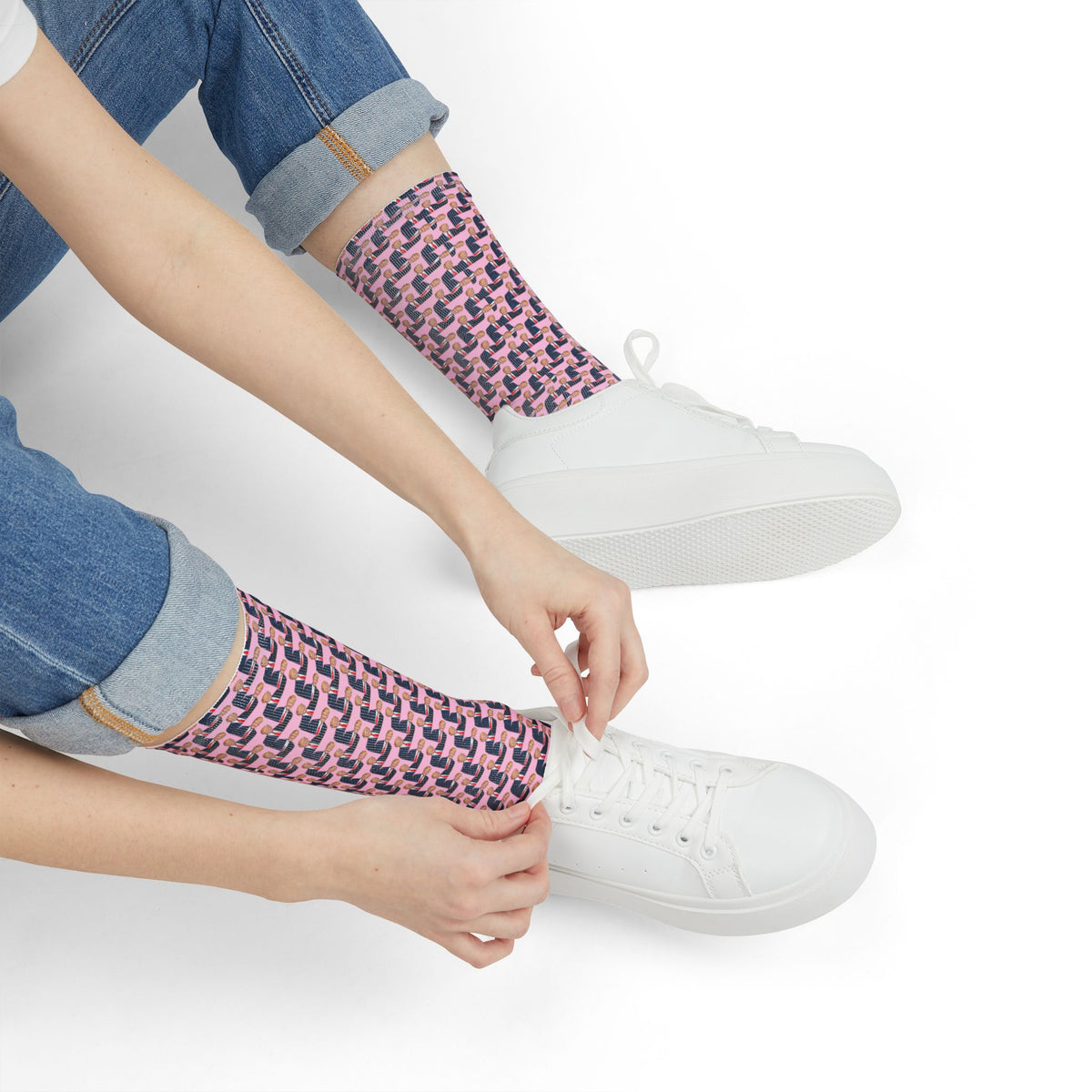 Close-up of Donald Trump pink crew socks worn with white sneakers and cuffed jeans