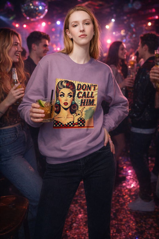 Person wearing Don’t Call Him retro pop art sweatshirt in a nightlife bar setting with colorful lights.