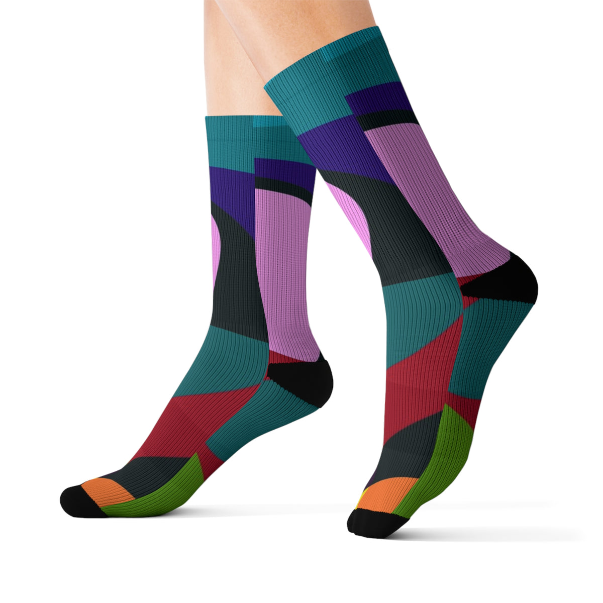 Earthy Colors Swirl crew socks worn on crossed legs with bold multicolor abstract pattern.