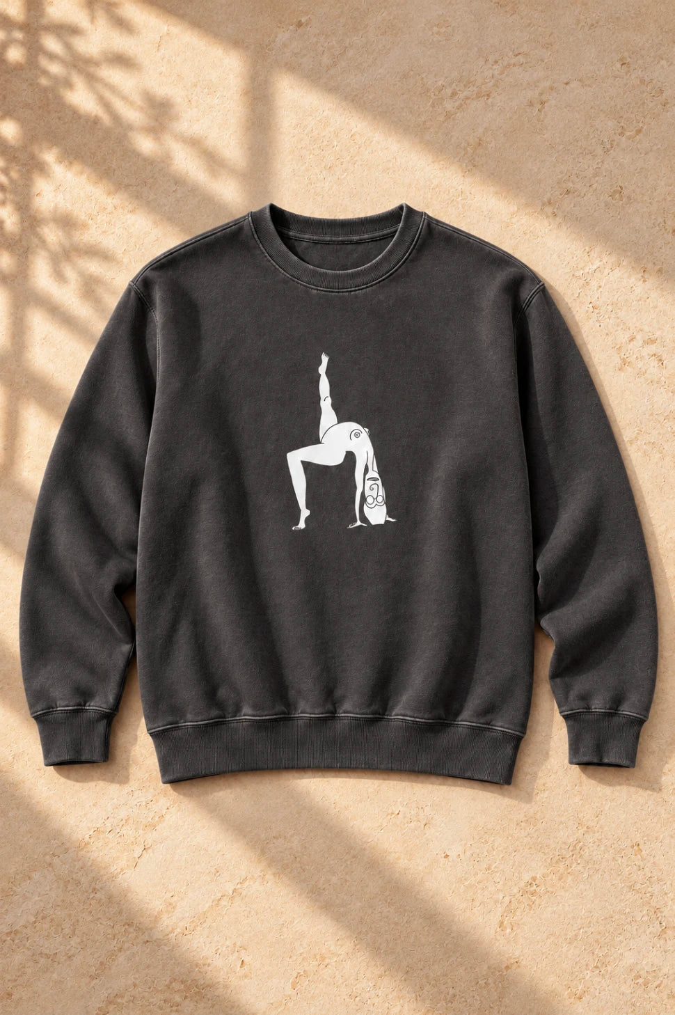 Black Elastika Girl graphic crewneck sweatshirt with minimalist white illustrated artwork on a warm neutral background.