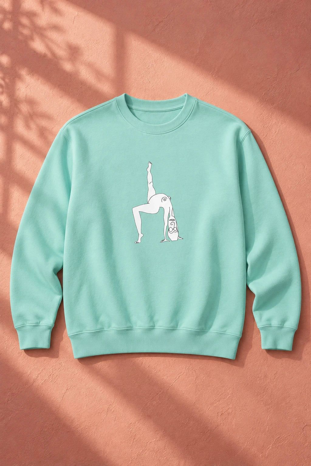 Chalky Mint Elastika Girl crewneck sweatshirt with white illustrated graphic on a warm terracotta background.