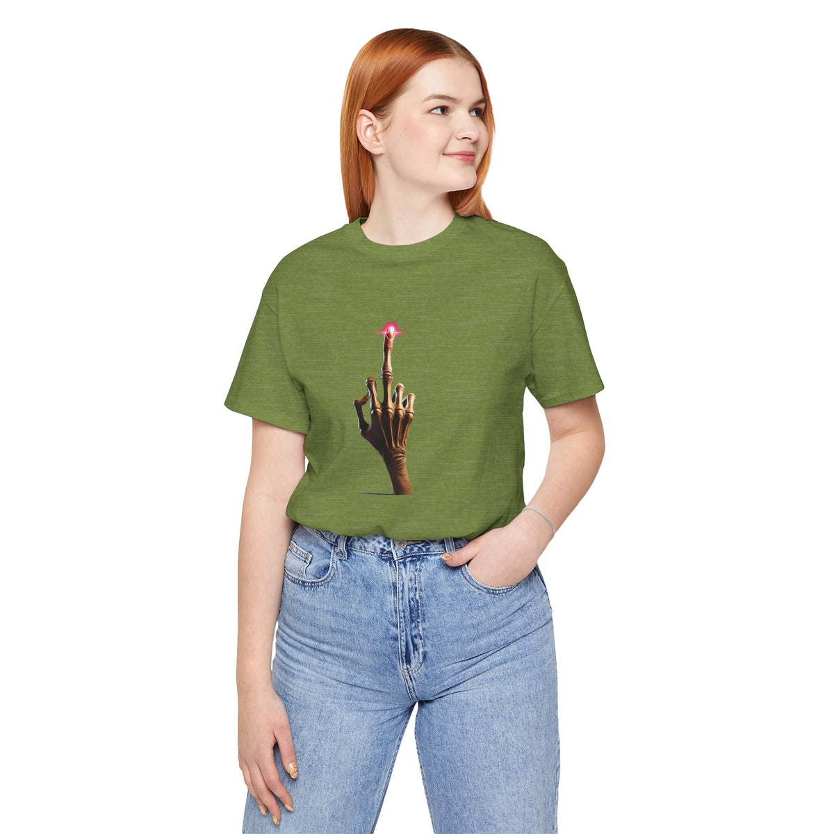 Woman modeling an olive green alien middle finger T-shirt tucked into light blue jeans.