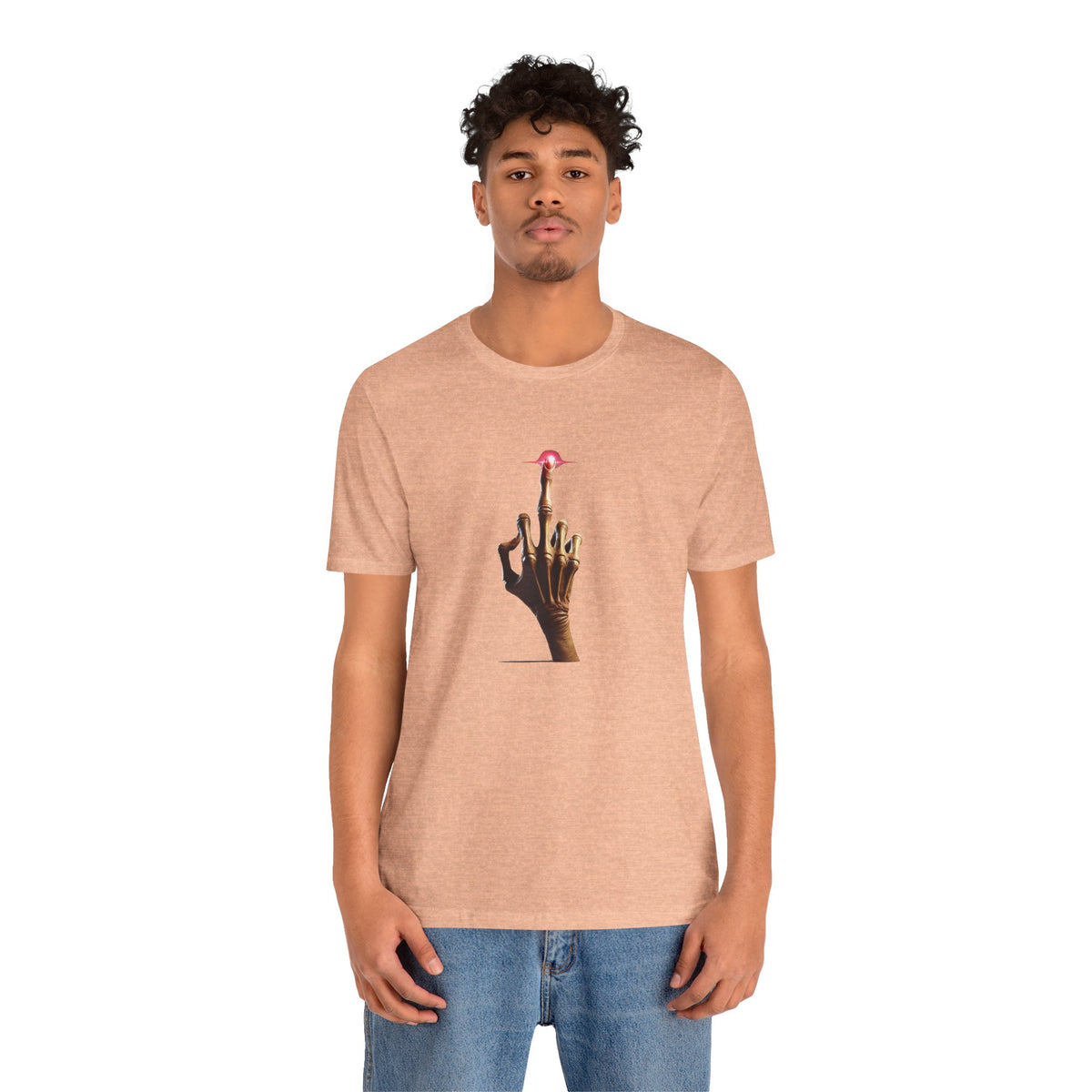 Man wearing a peach T-shirt with a centered alien middle finger graphic and blue jeans.