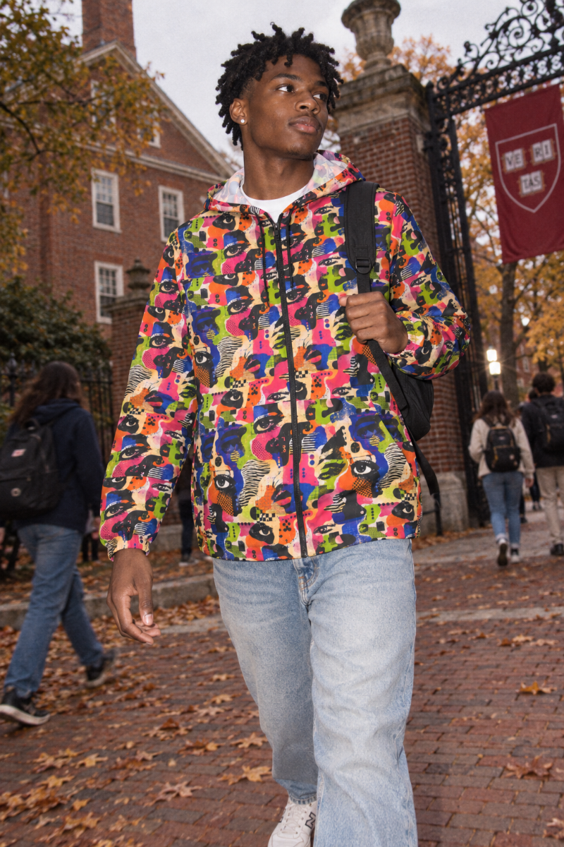 Male Gen Z wearing Face Static adversarial windbreaker on Harvard campus in autumn