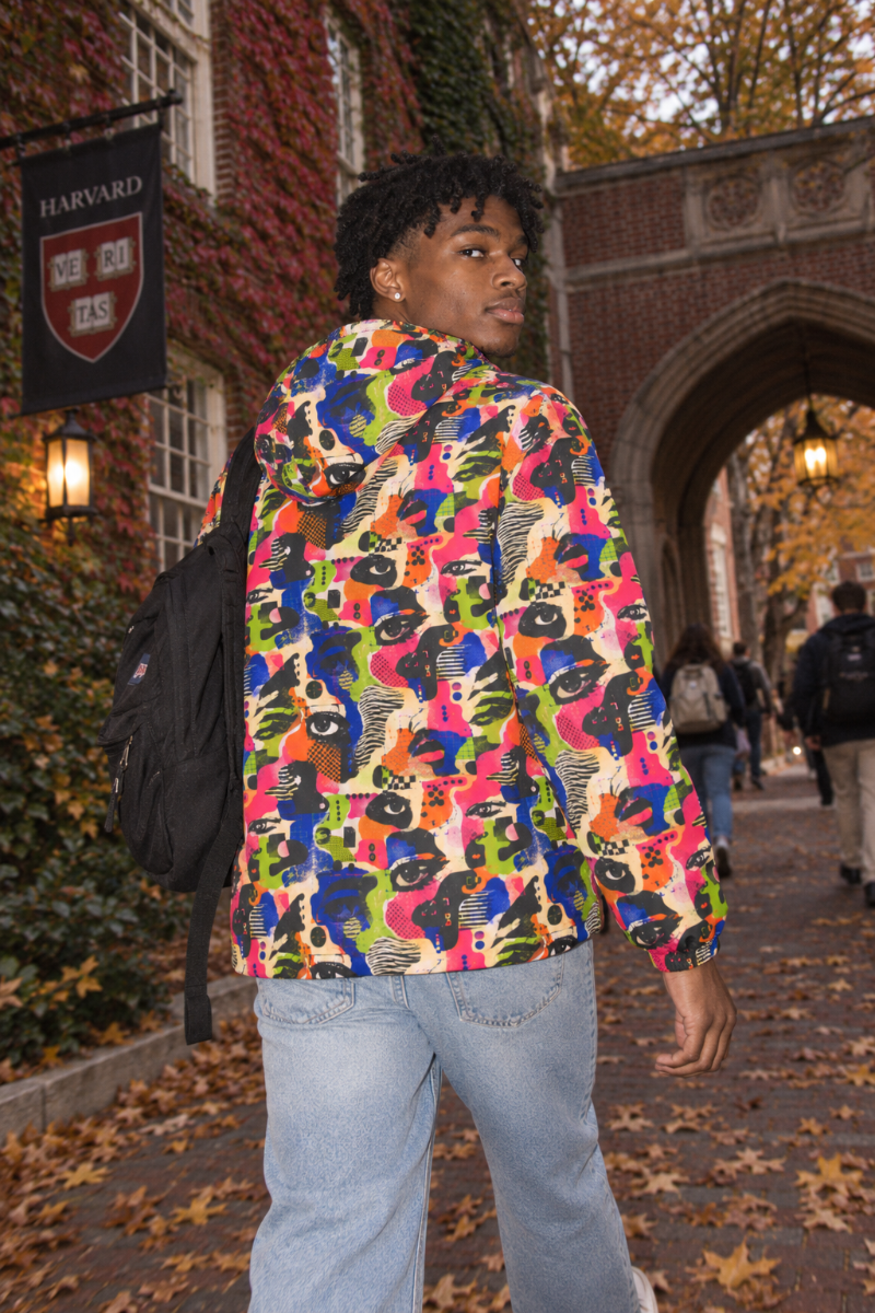 Male Gen Z wearing colorful Face Static techwear windbreaker back view on Harvard campus