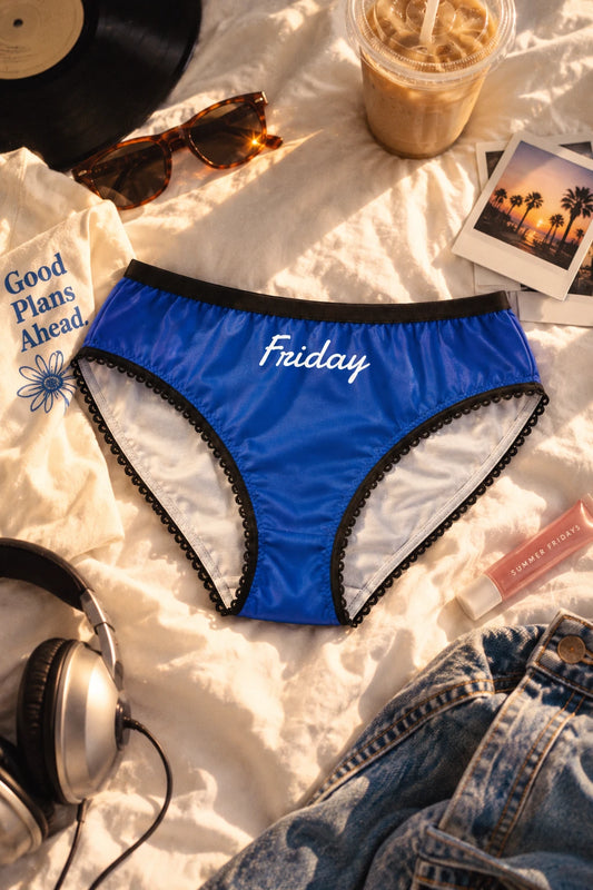 Friday Panty blue women’s briefs in a youthful lifestyle flat lay with black trim and white script