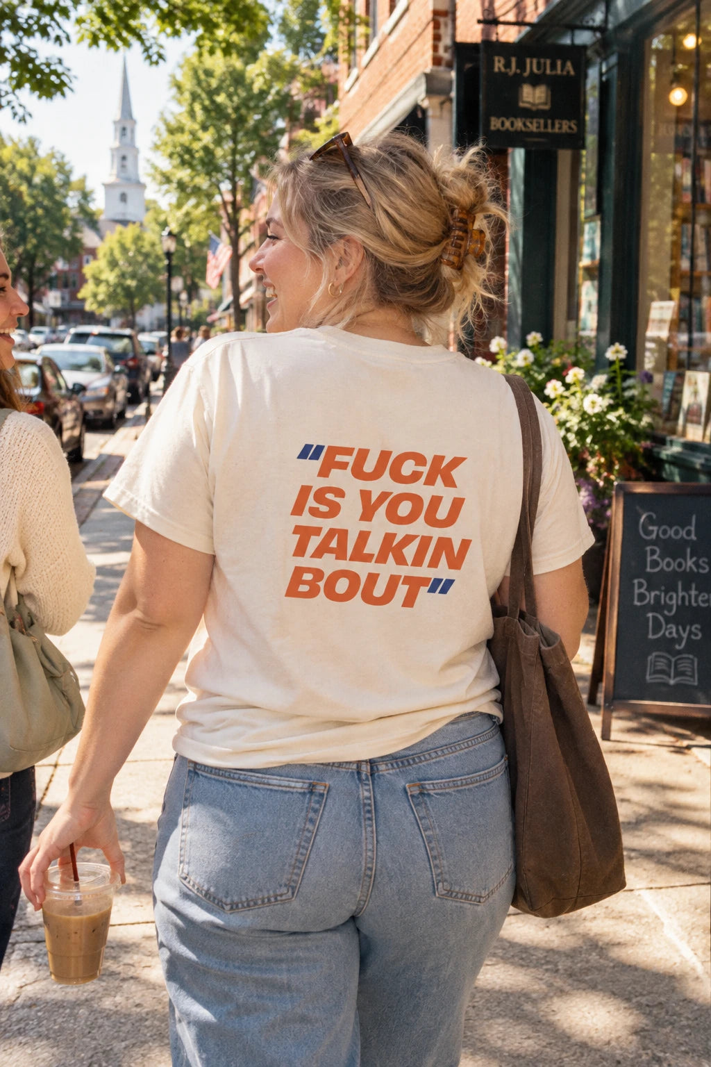 Woman wearing cream Fuck Is You Talkin Bout back print graphic t-shirt in a Connecticut town setting