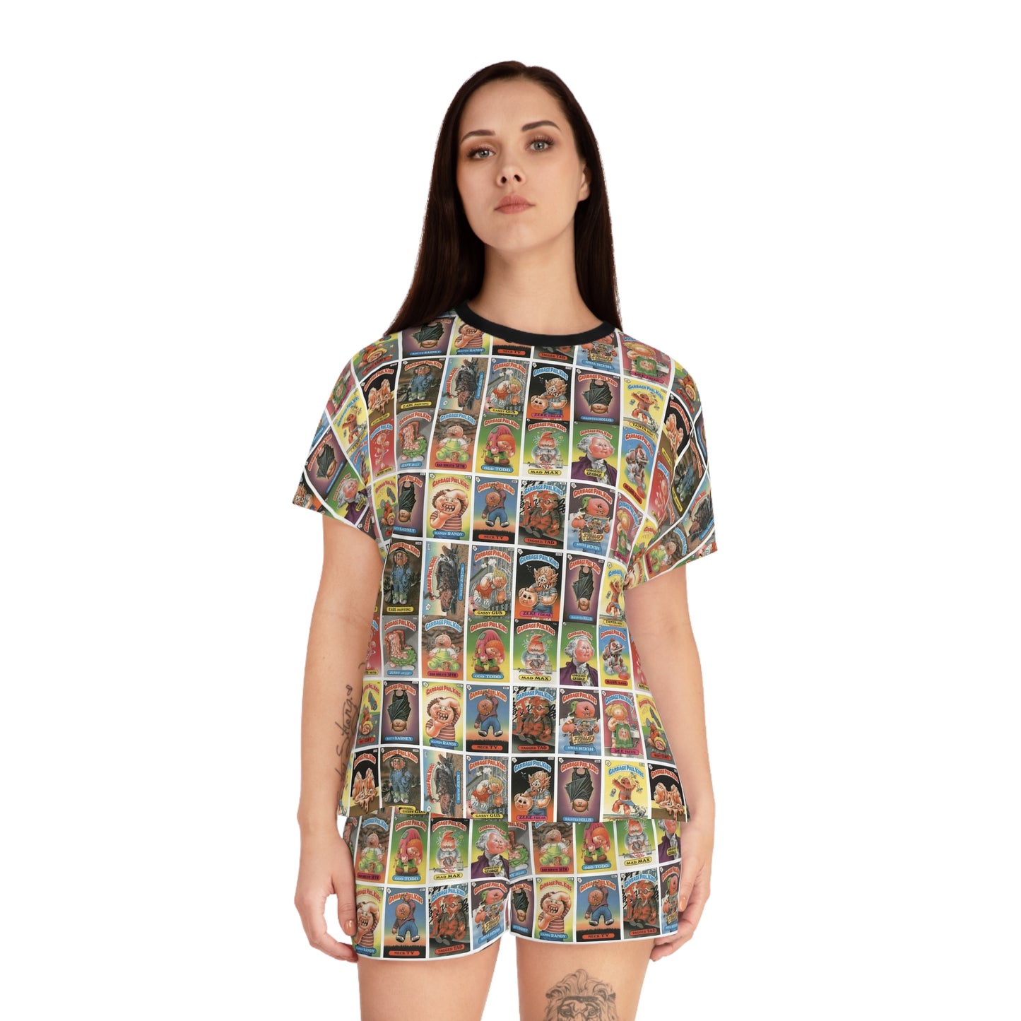 Model wearing Garbage Pail Kids inspired satin pajama set with colorful retro trading card collage print and oversized pop art sleepwear aesthetic.