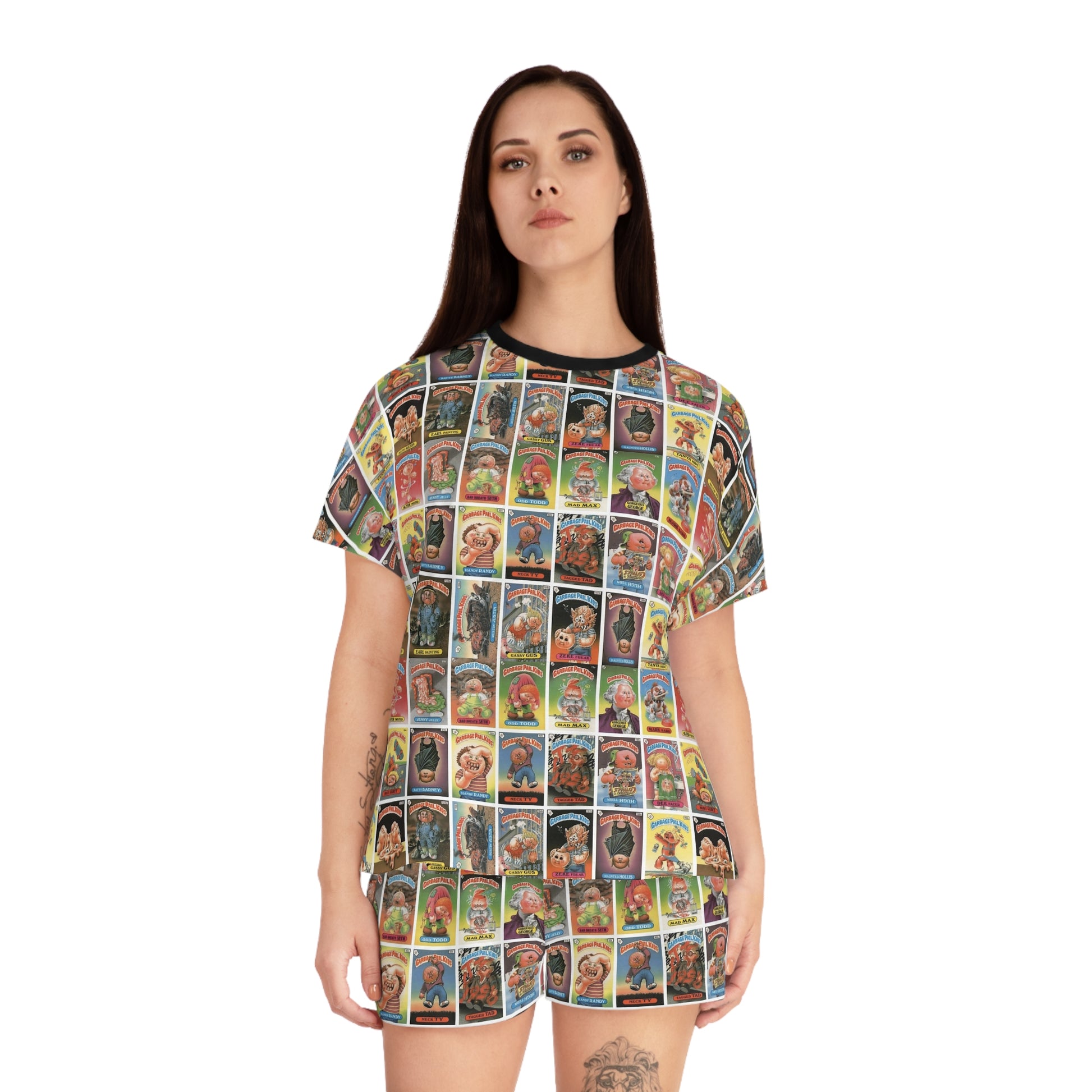 Model wearing Garbage Pail Kids inspired satin pajama set with colorful retro trading card collage print and oversized pop art sleepwear aesthetic.