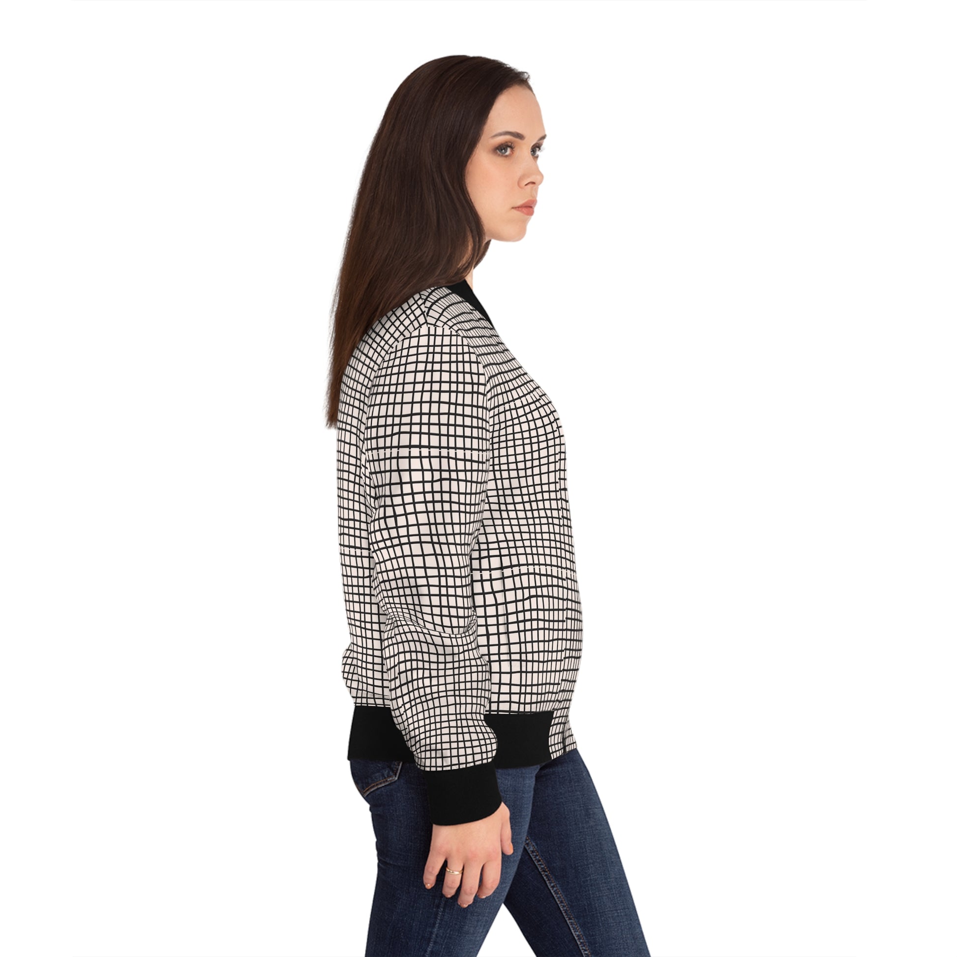 Side view of woman wearing a black and white grid print bomber jacket.