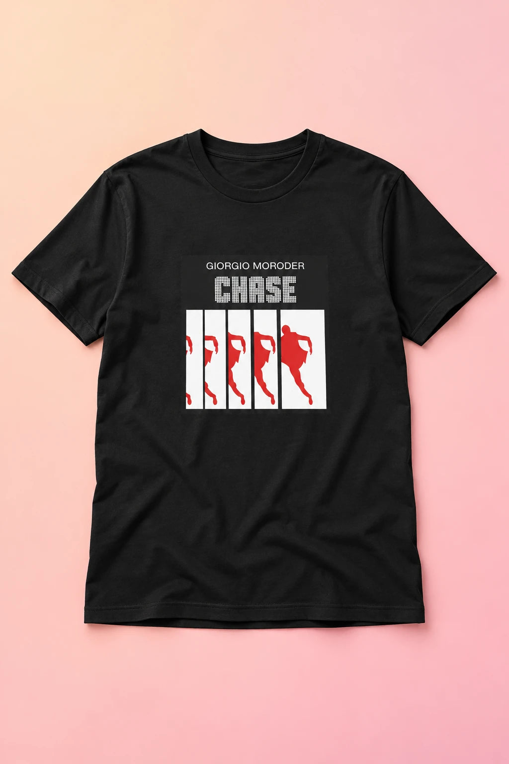 Black Giorgio Moroder Chase T-shirt laid flat on a soft peach and pink gradient background.