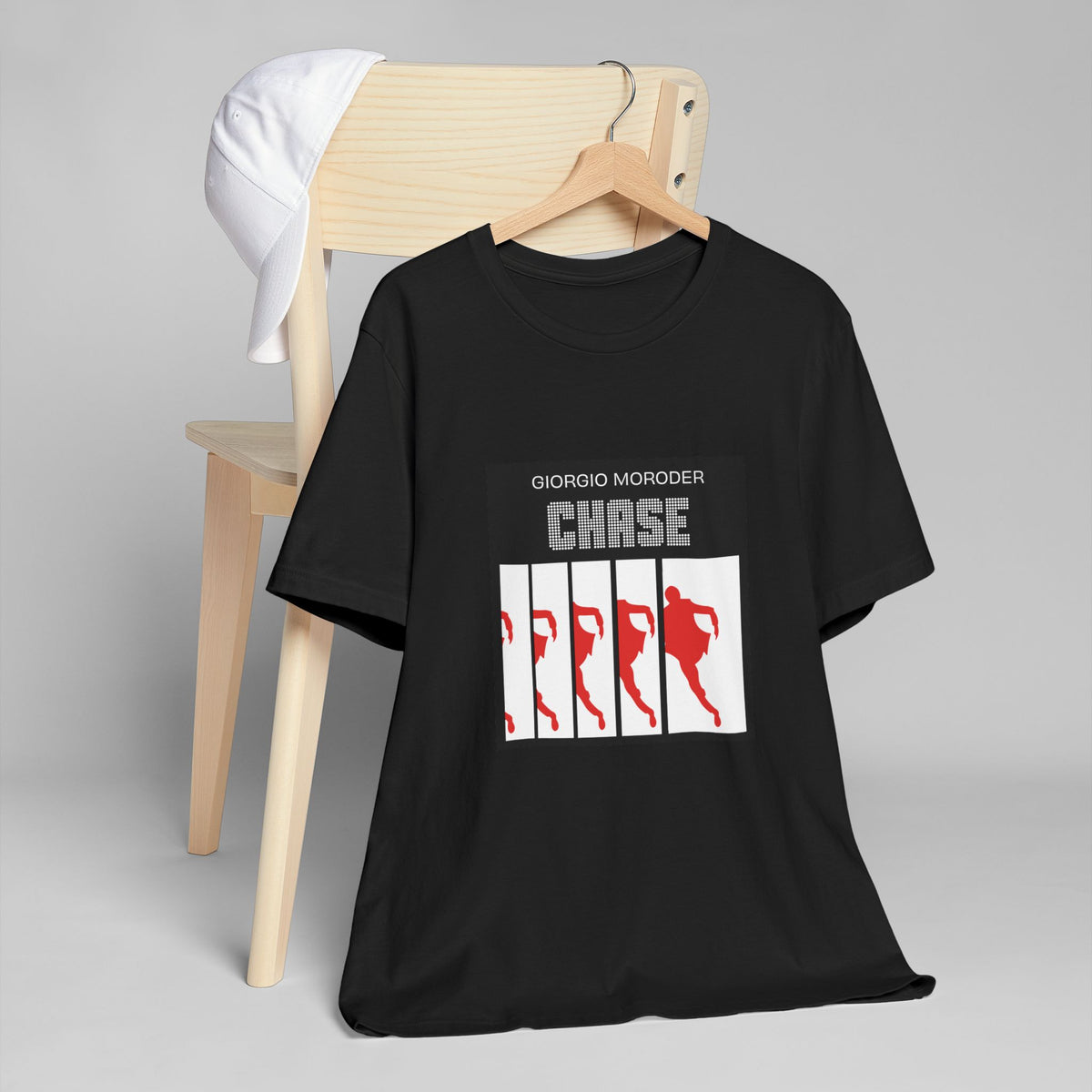 Black crewneck T-shirt on a wooden hanger, featuring Giorgio Moroder Chase lettering and red running silhouettes.