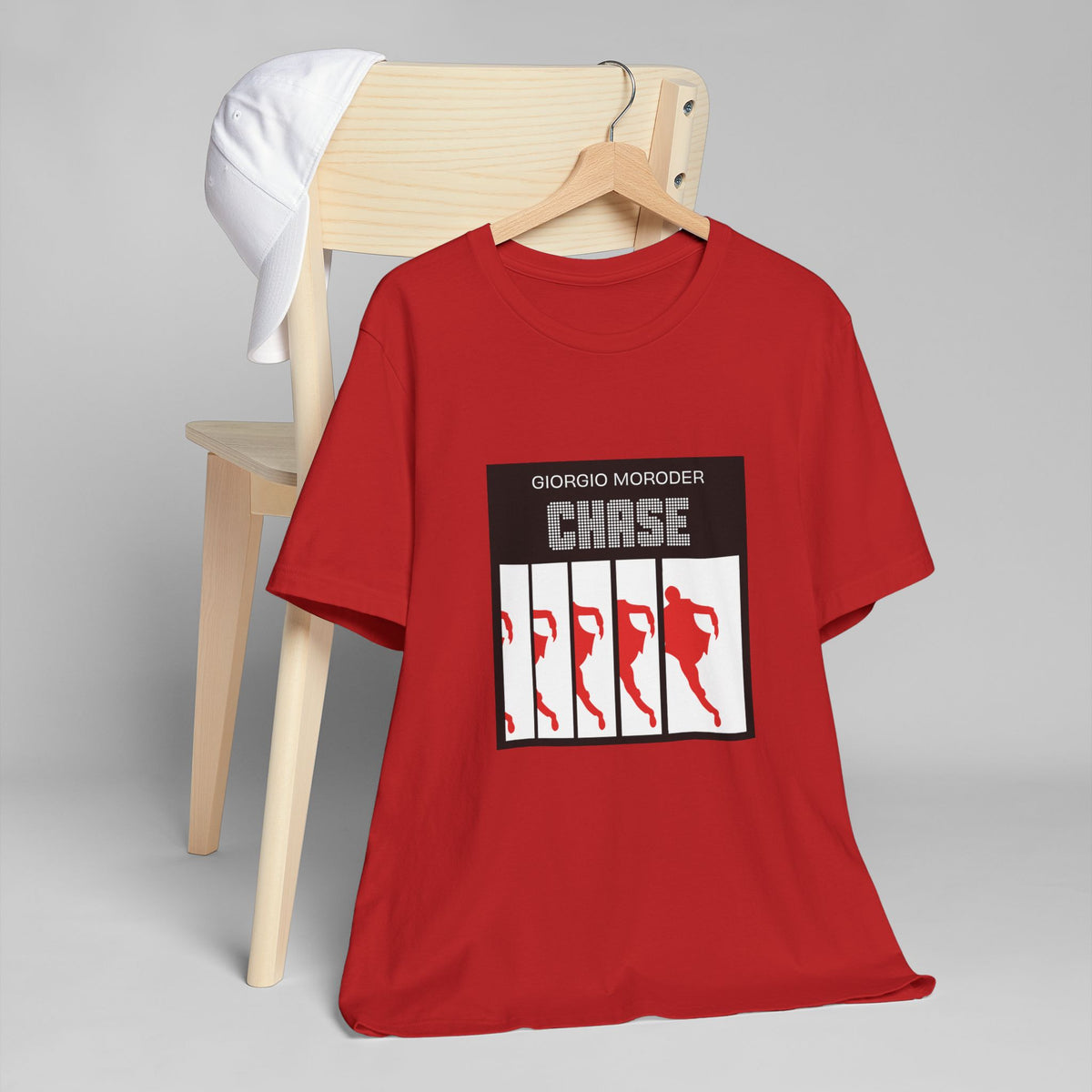 Red Giorgio Moroder Chase T-shirt on a wooden hanger, featuring the single-cover graphic with running silhouettes.