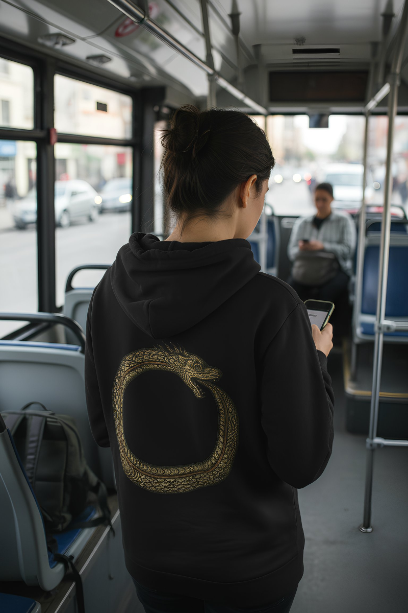 Person wearing black Good Karma hoodie inside a bus