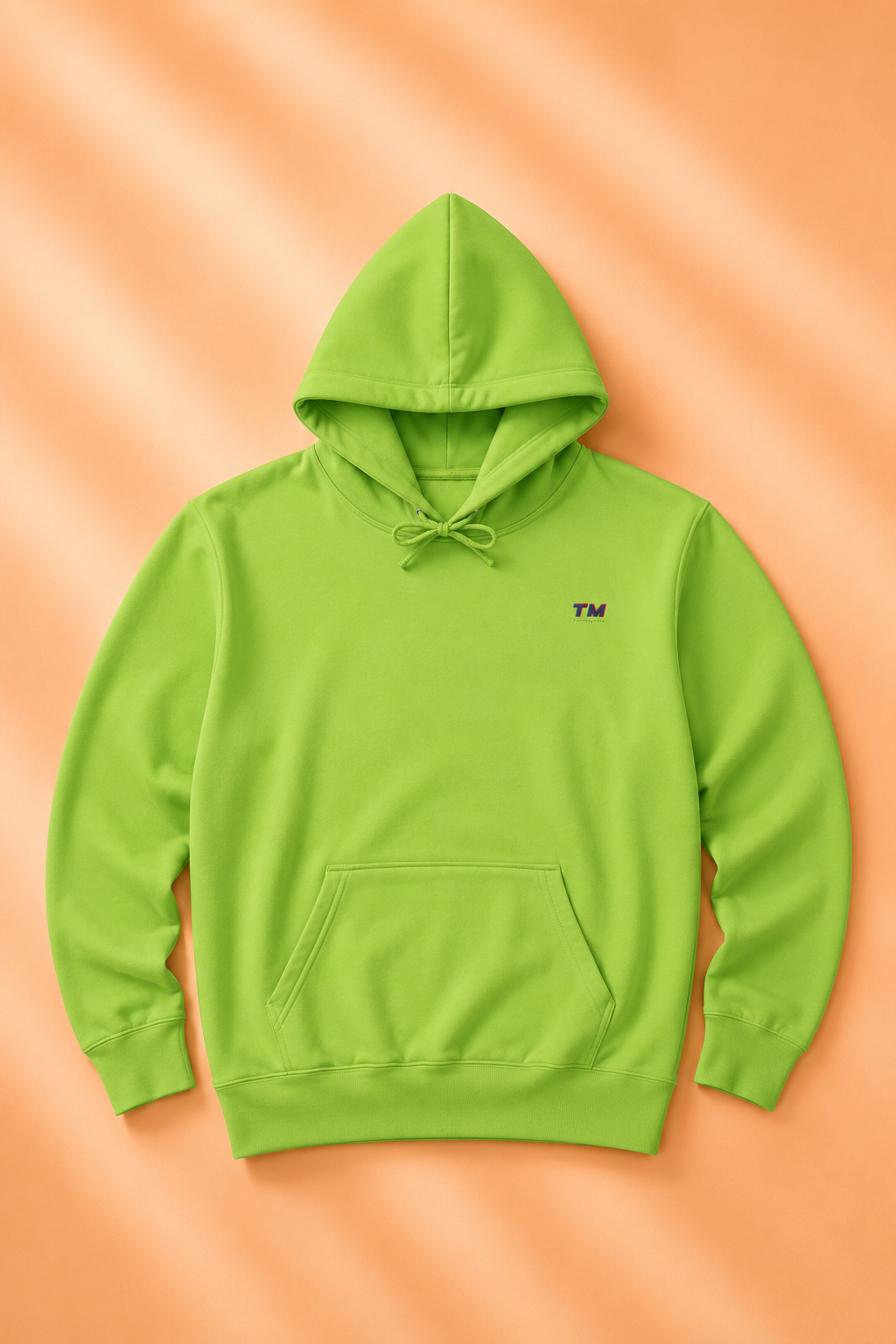 Tantrum Media EcoSmart green hoodie flat lay on a soft pastel orange background.