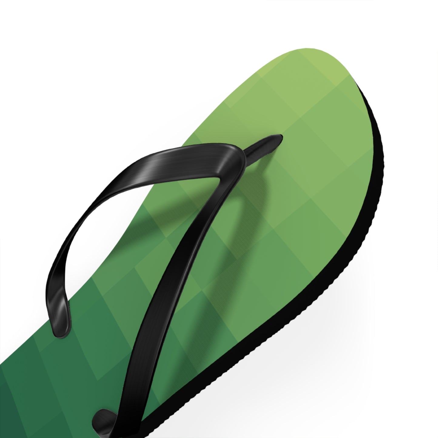 Close-up detail of green pixel-inspired flip flops with black straps and retro gaming aesthetic