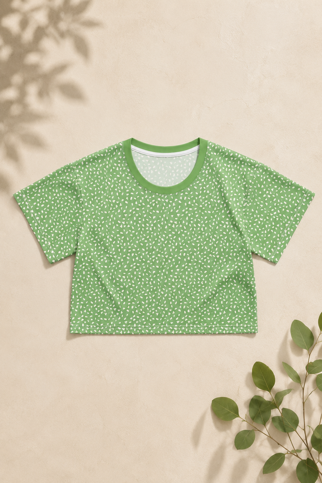 Green speckled crop top styled in minimalist editorial flat lay with soft neutral aesthetic