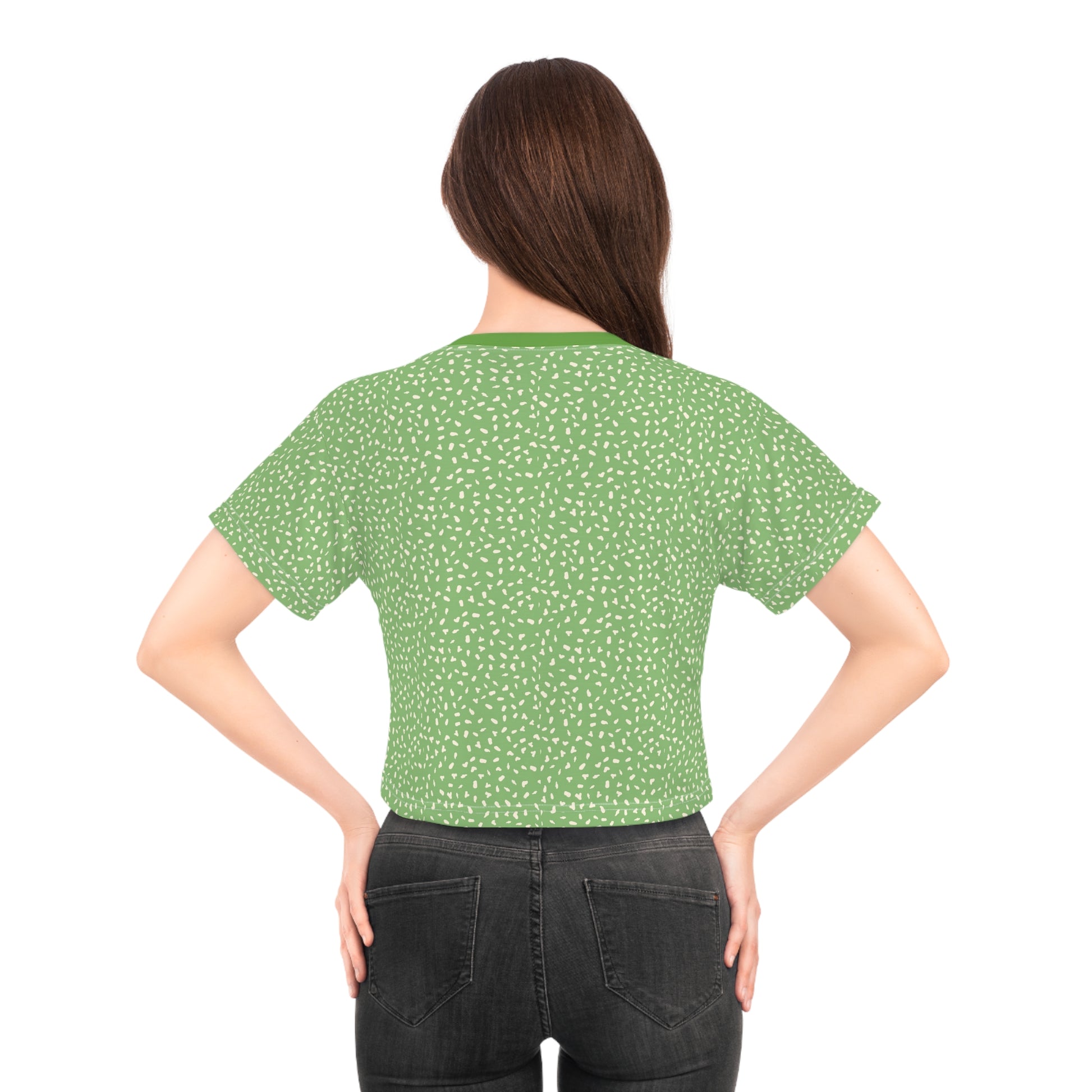 Back view of female model wearing green speckled crop top with minimalist streetwear aesthetic