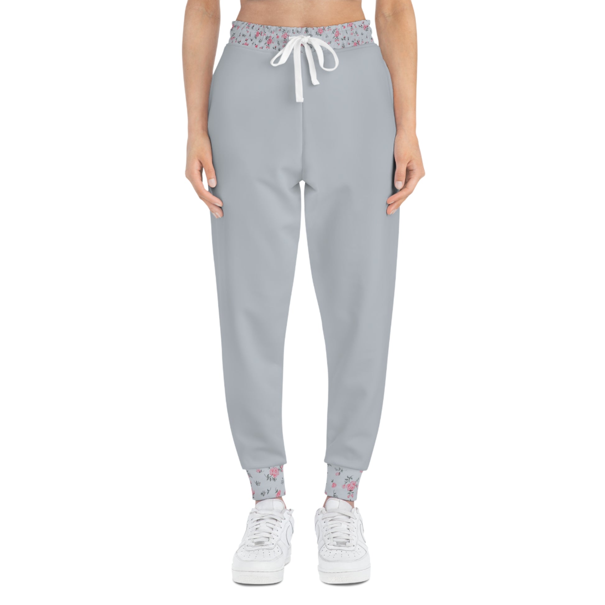 Grey floral joggers featuring a relaxed unisex fit and floral accents