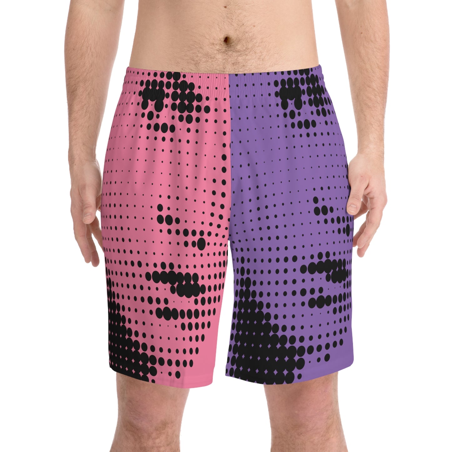 Model wearing colorful halftone face men’s beach shorts with retro graphic art print
