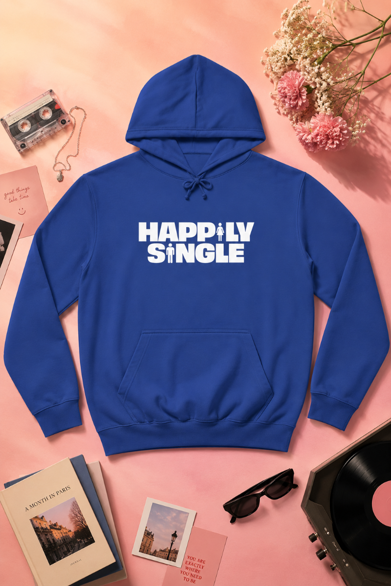 Blue Happily Single hoodie flat lay on soft peach background with flowers and retro accessories