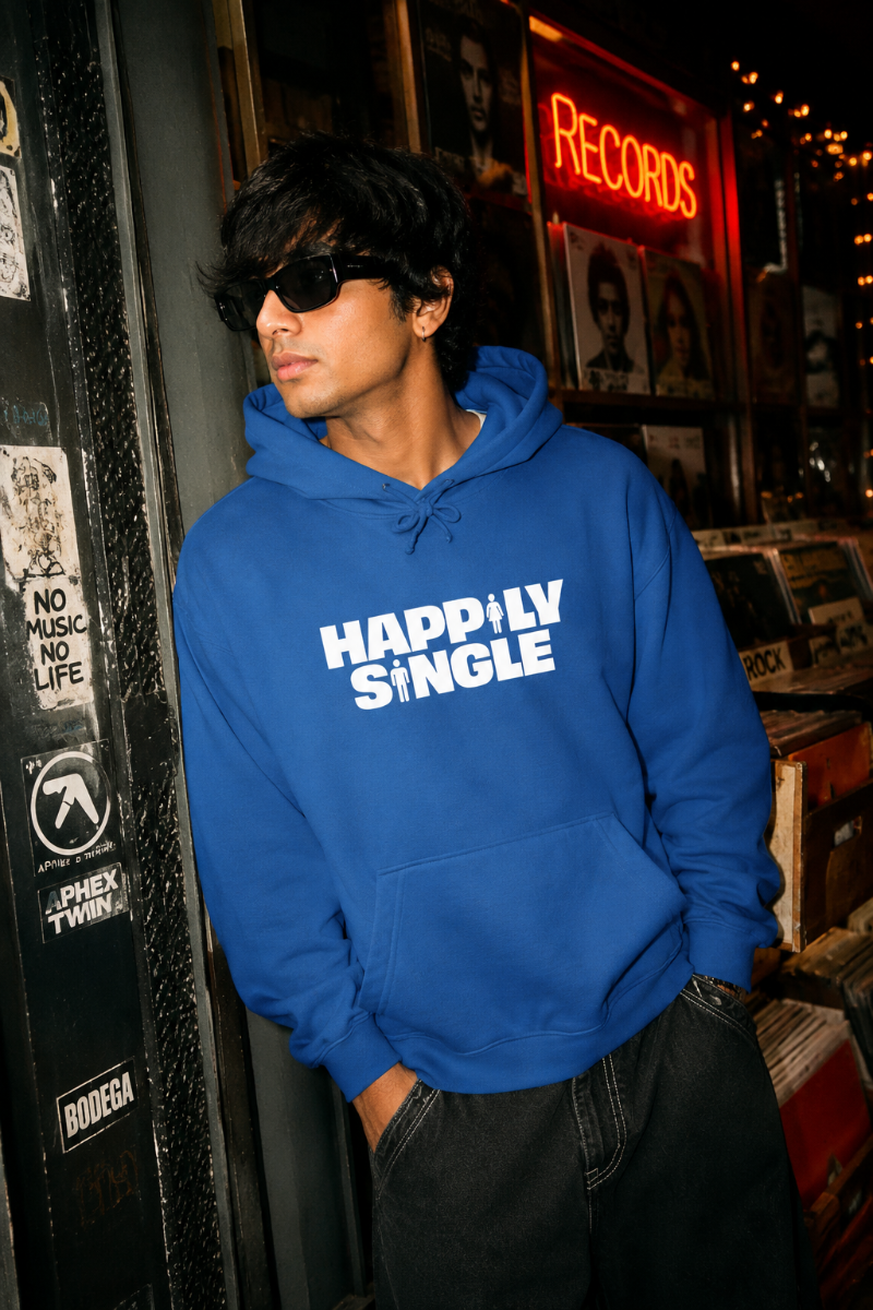 Gen Z model wearing blue Happily Single hoodie outside an urban record store