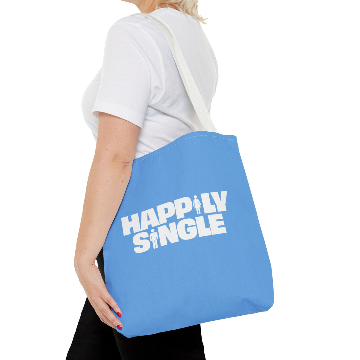 Female model wearing a blue Happily Single tote bag with white shoulder straps.