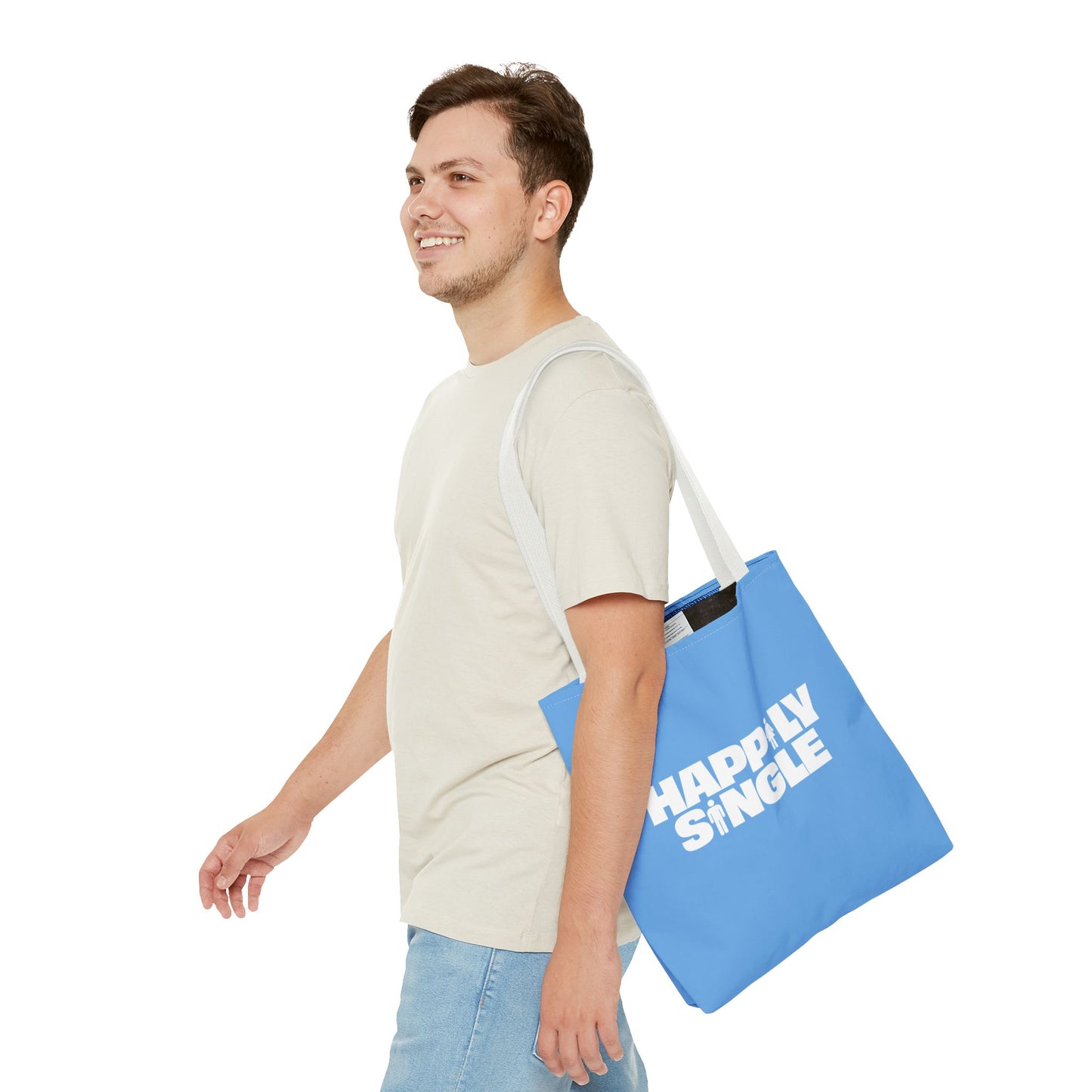 Male model carrying a blue Happily Single tote bag with long white shoulder straps.