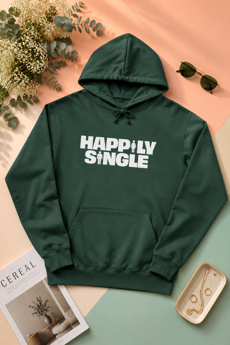 Dark green Happily Single hoodie flat lay on peach and mint pastel background