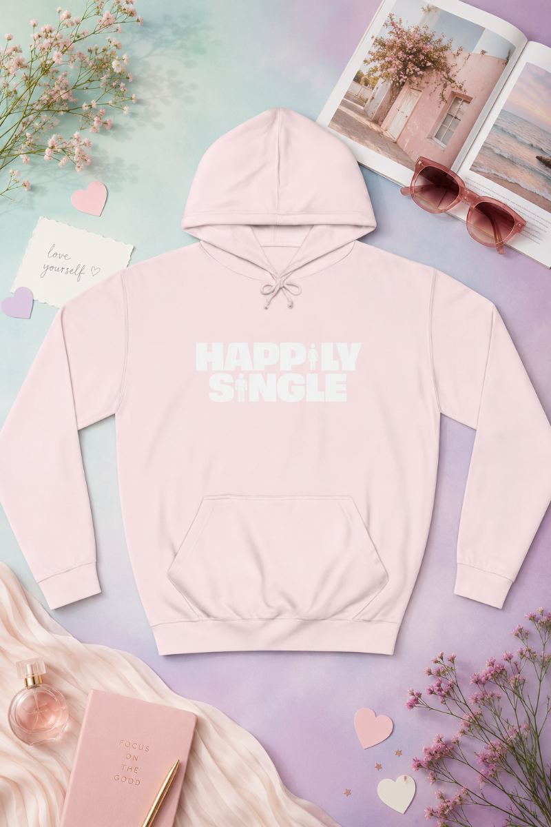 Light pink Happily Single hoodie flat lay on soft pastel gradient background