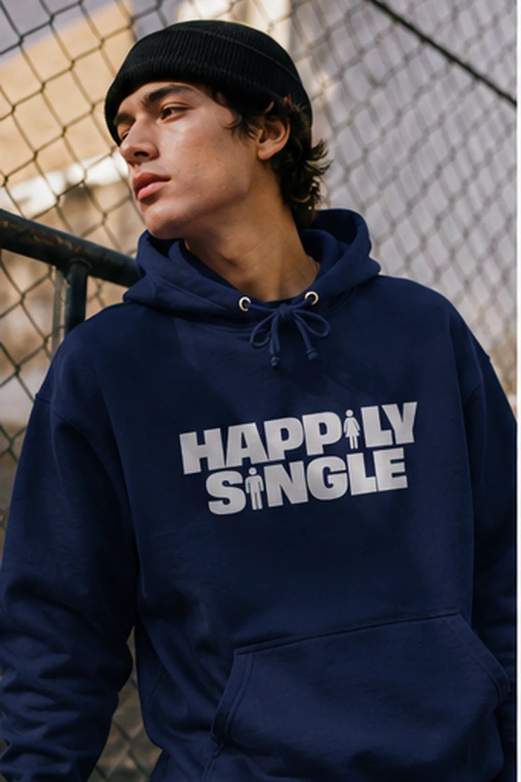 Gen Z man wearing navy Happily Single hoodie beside urban basketball court