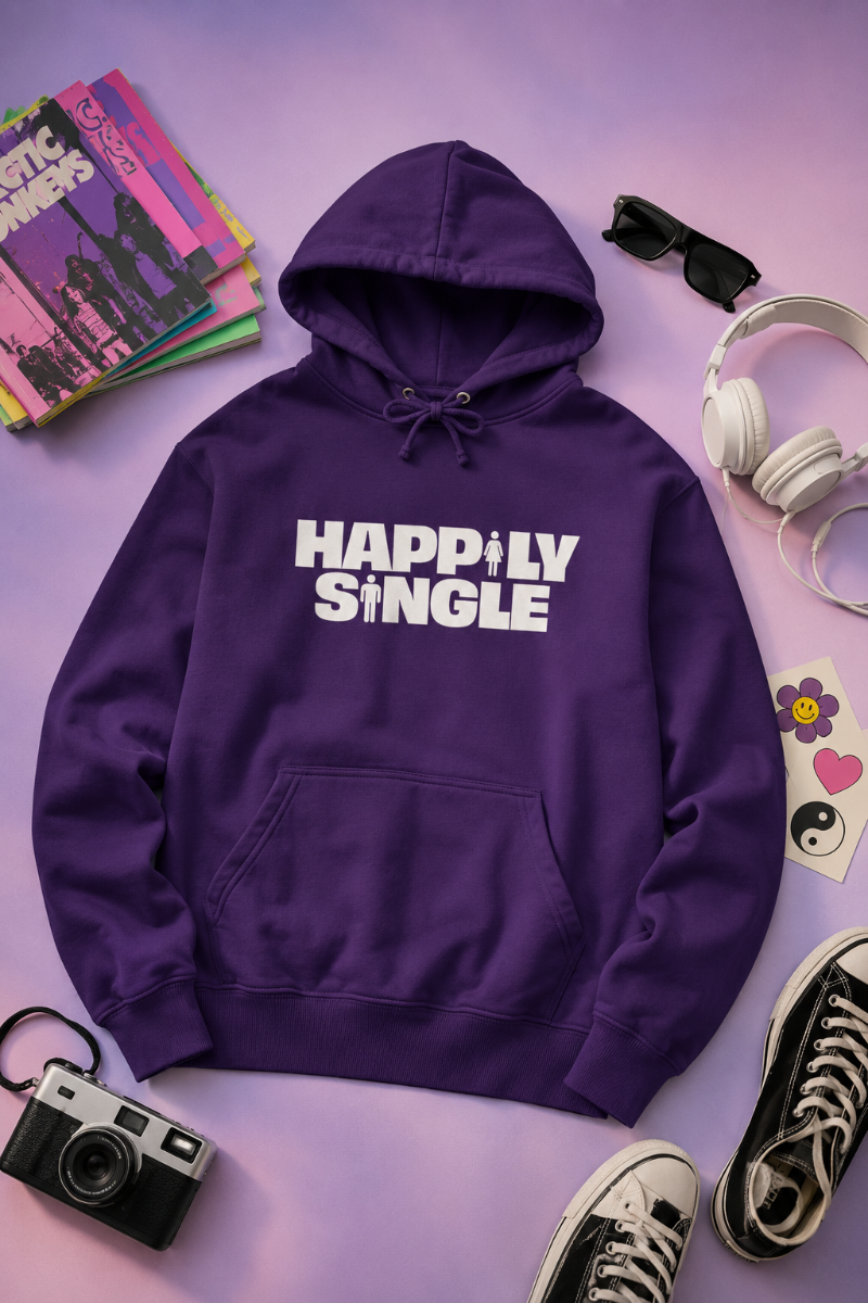 Purple Happily Single hoodie flat lay on lavender and pink background with retro accessories