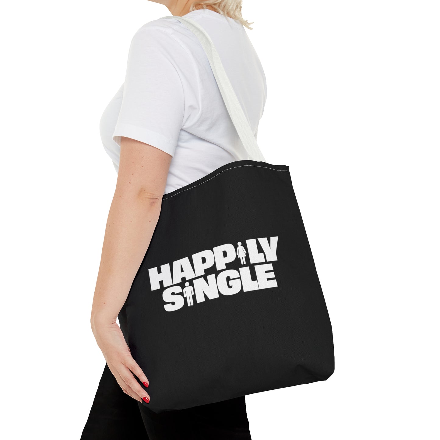 Female model carrying a black Happily Single tote bag with long white shoulder straps.