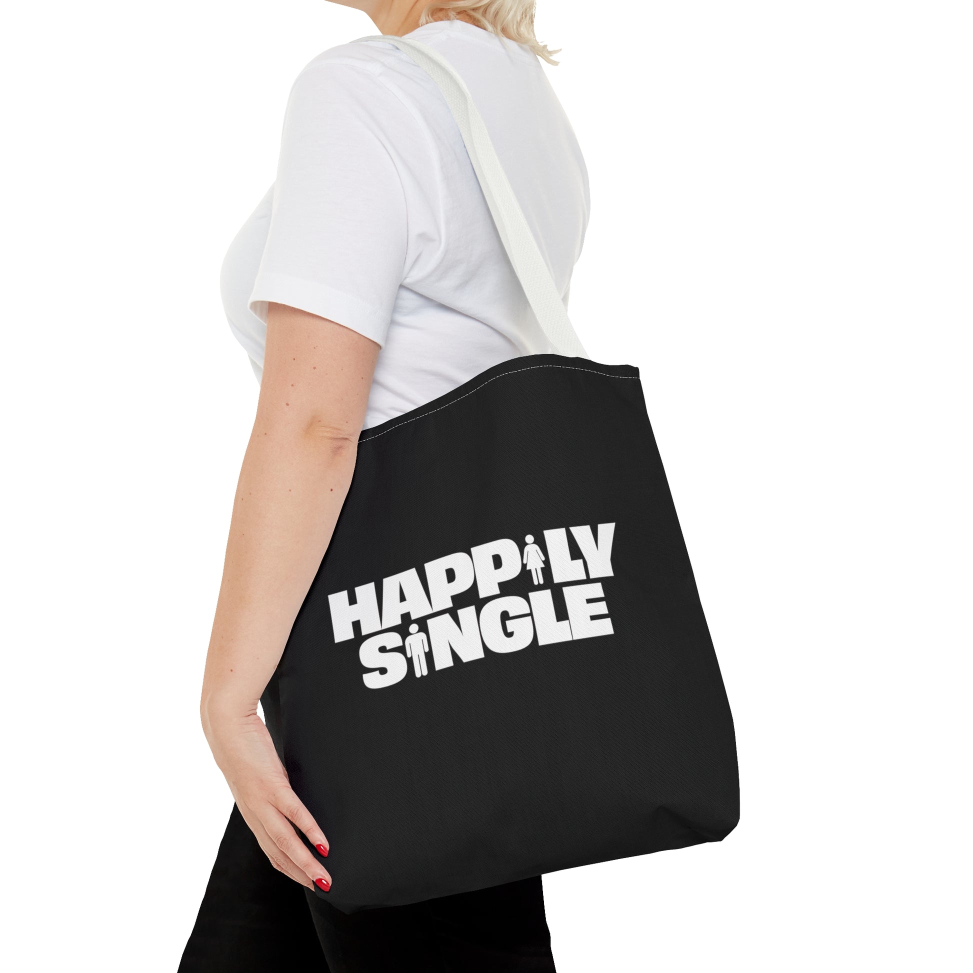 Female model carrying a black Happily Single tote bag with long white shoulder straps.