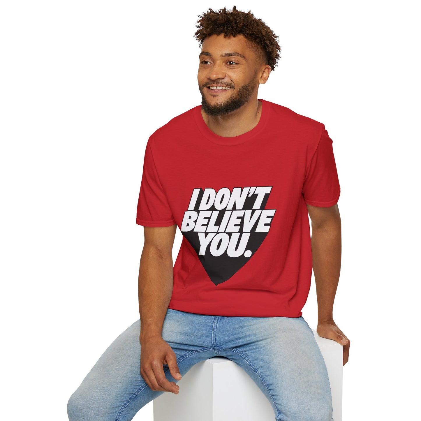 Male model sitting wearing red “I Don’t Believe You” bold statement t-shirt
