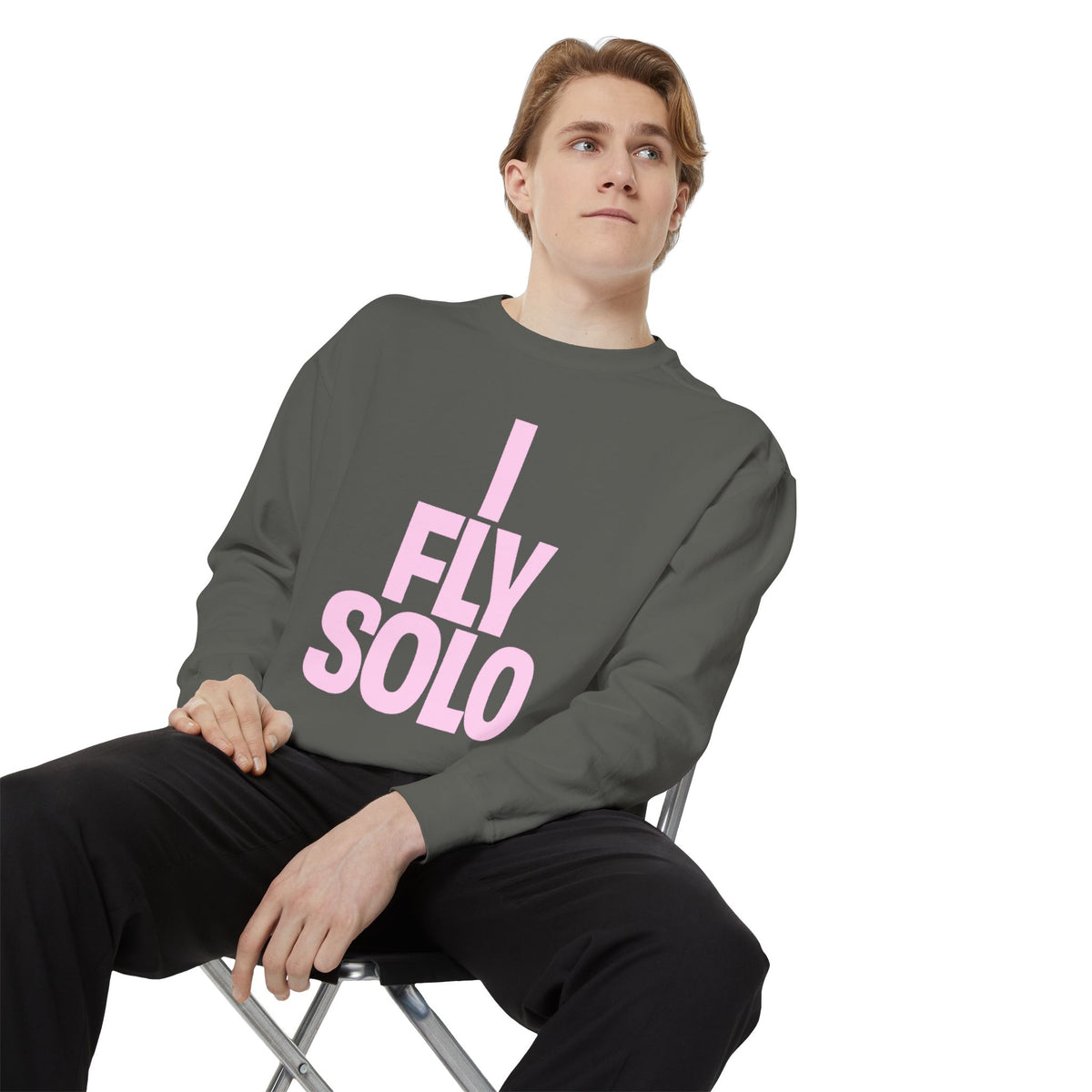 I Fly Solo Unisex Sweatshirt in pepper worn by seated male model
