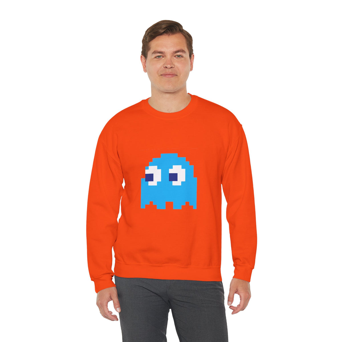 Person wearing an orange sweatshirt with a blue ghost graphic on a white background