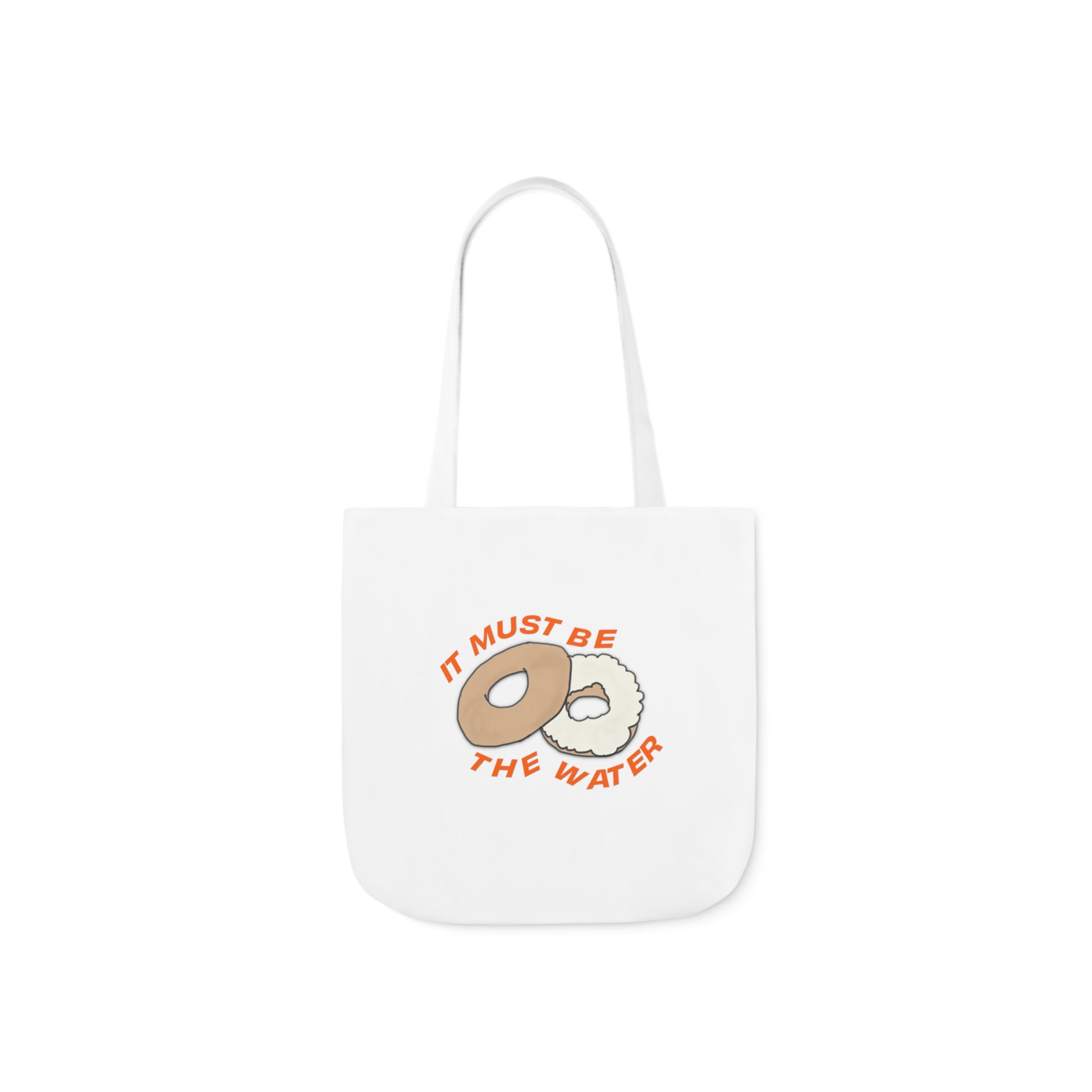 White hand-drawn NYC bagel tote bag with It Must Be The Water artwork on the front.