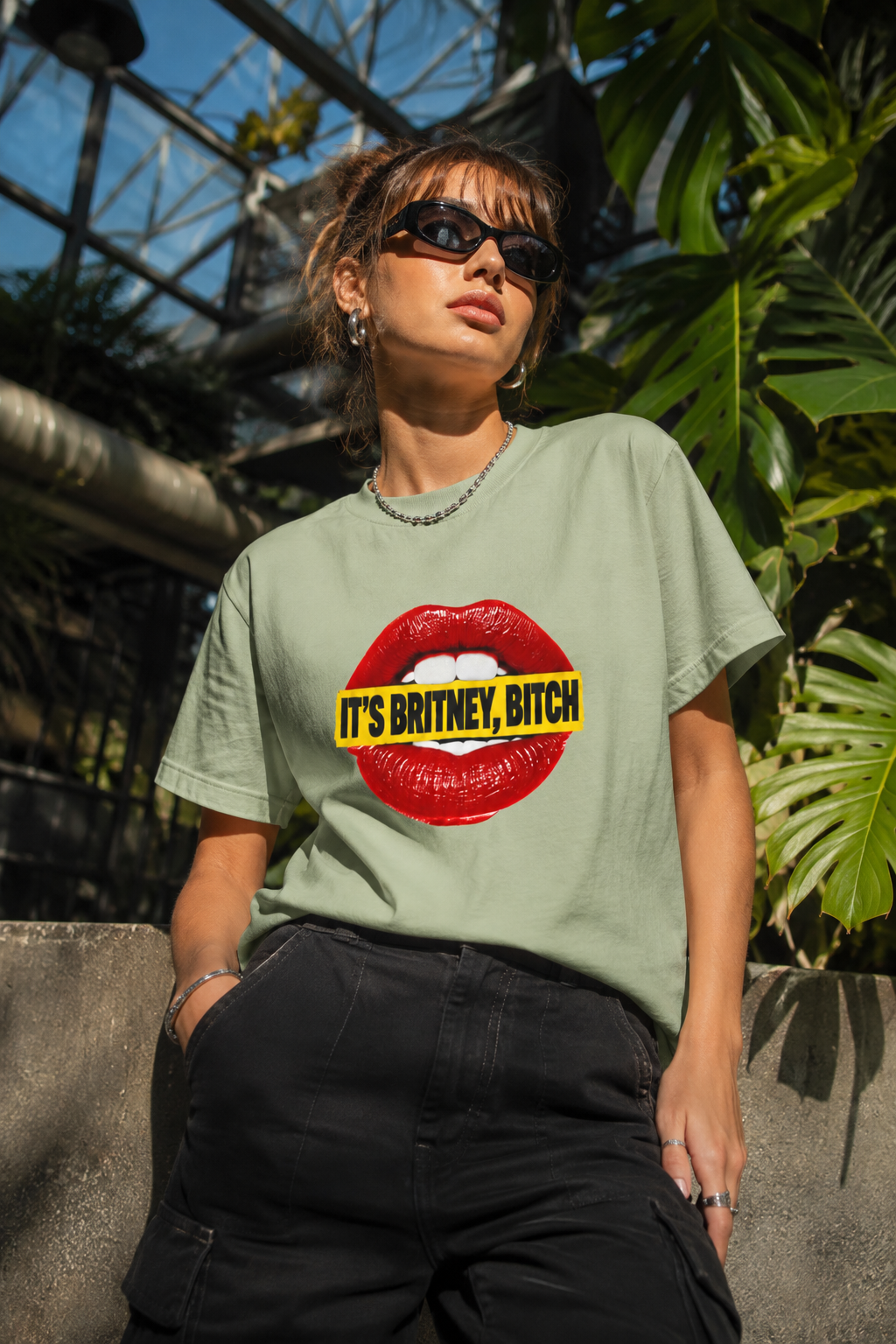 Front view of the pink It’s Britney, Bitch graphic T-shirt with glossy red lips and yellow text banner.
