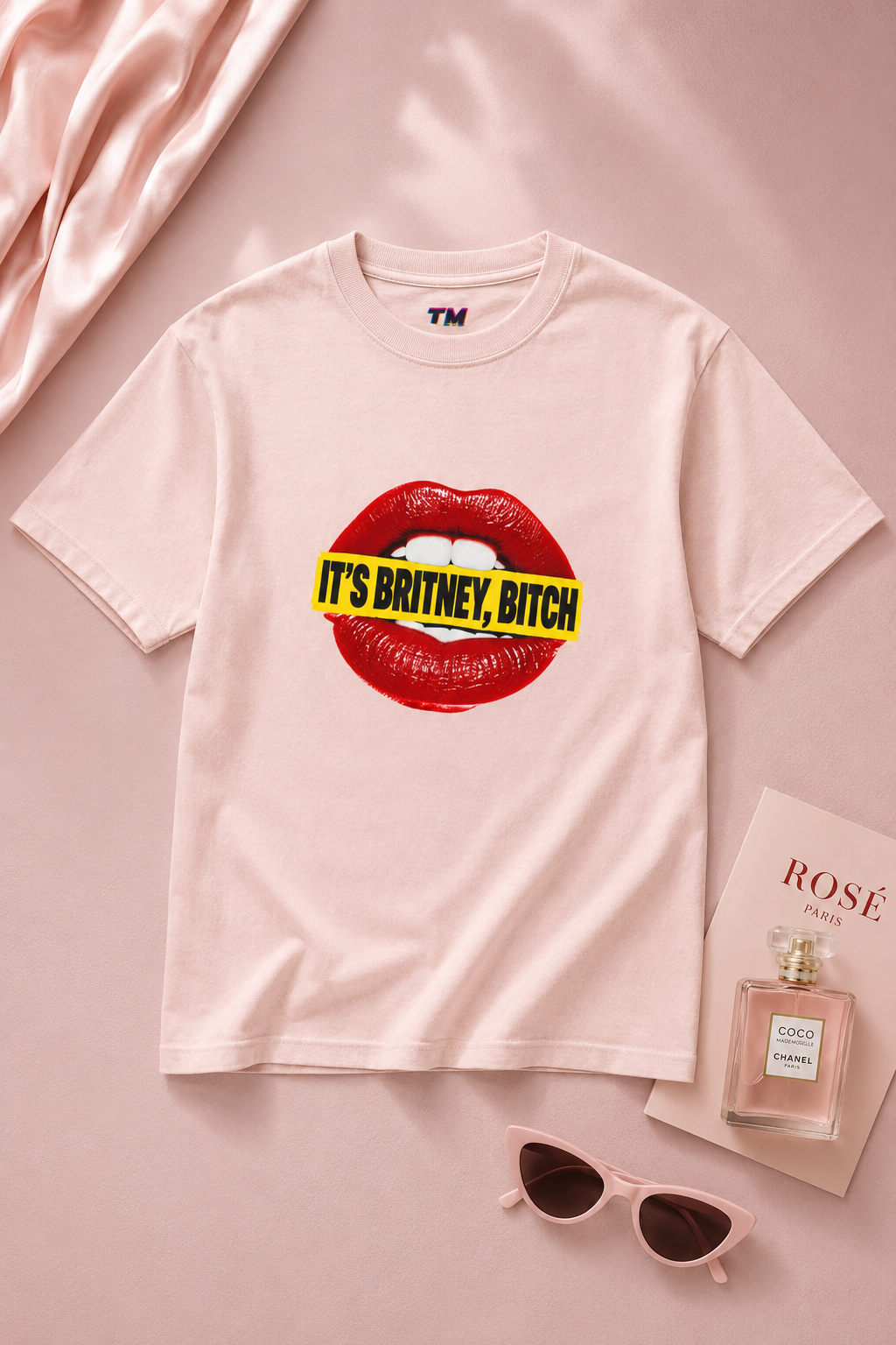 Pink It’s Britney, Bitch Britney Spears homage graphic T-shirt in a cinematic editorial flat lay.